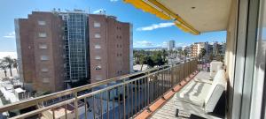 a balcony with a view of a city at Apartamento 1 línea de playa + Parking! Salou in Salou