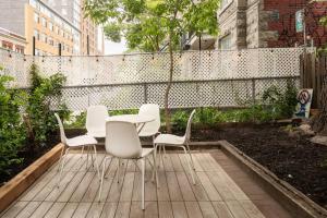 a table and chairs sitting on a wooden deck at Le Milton Open Concept Natural Sunlight Backyard in Montréal