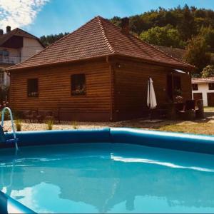 a house with a swimming pool in front of a house at Mátrai pincés udvar in Mátramindszent