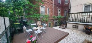 un balcone con tavolo e sedie su una terrazza in legno di Lemiltonplace Beautifully Renovated 4 Ur Enjoyment a Montréal
