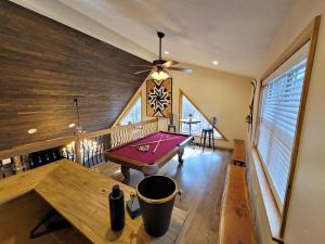 a pool table in a room with a ceiling at Swept Away Chalet - Luxurious NEW 6 BR Home Sleeps 16 Hot Tub Linens and Towels in Albrightsville