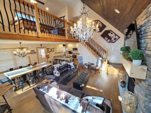 a large living room with couches and a dining room at Swept Away Chalet - Luxurious NEW 6 BR Home Sleeps 16 Hot Tub Linens and Towels in Albrightsville +89 photos