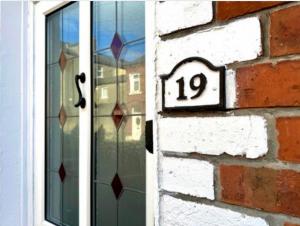 a door with a number on it next to a window at Bloom19 Traditional Belfast house 10 mins from city centre in Belfast