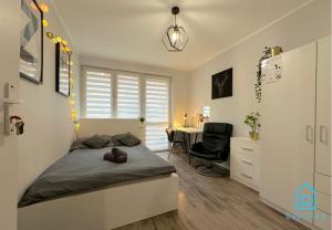 a bedroom with a bed and a desk with a chair at Jager Room 10 Min to Old Town Gdańsk,PKP & Shopping Mall in Gdańsk