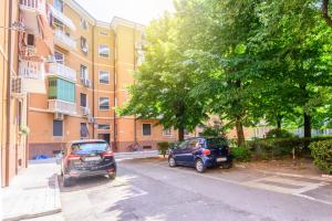 维罗纳Casa Porta Nuova Verona的两辆汽车停在一栋建筑前的停车场