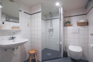 a bathroom with a shower and a sink and a toilet at Hotel Fase Fier Eten en Drinken in Castricum +21 photos