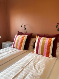 a bed with two pillows on it in a room at Setberg Guesthouse in Nesjum