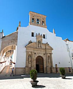 a building with a clock tower on top of it at Ocón 2 in Lebrija