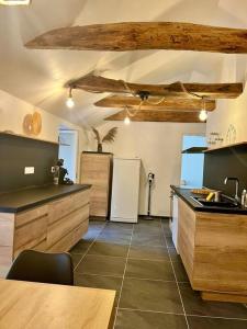 a large kitchen with wooden cabinets and a white refrigerator at Appartement Nicolas in Aujac +7 photos