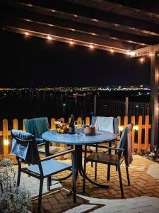 a table and chairs on a patio at night at Sibiu City Lights in Şura Mare