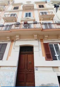 a building with a wooden door and a balcony at YOUR HOME 26 in Bari