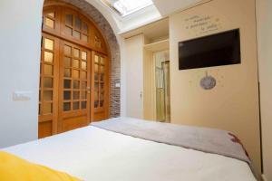 a bedroom with a bed and a flat screen tv at Le Petit Prince in Rome