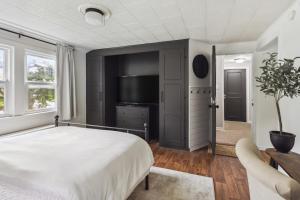 a bedroom with a bed and a flat screen tv at Large Private Studio Apartment in Lockport