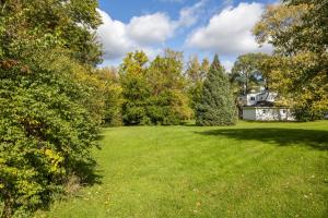 a large yard with trees and a house at Large Private Studio Apartment in Lockport