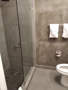 a bathroom with a shower with a toilet and towels at M HOTEL in Miami Beach