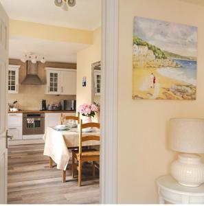 a kitchen with a table and a dining room at Beach House in Whitley Bay