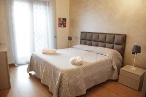 a bedroom with a bed with two towels on it at unica affittacamere in Rome