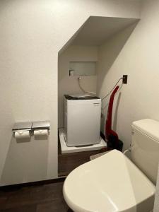 a bathroom with a toilet and a tv in it at Kobe Motomachi Roji Building - Vacation STAY 16195 in Kobe