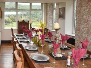 a dining room table with red paper birds on it at 12 Bed in Capel Curig 93368 in Capel Curig