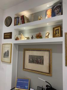 a shelf with a picture on a wall at Ecclesia Domus Vatican Inn in Rome