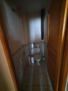 a bathroom with a toilet in a small room at Gîte de France La barthèçoice 3 épis - Gîte de France 7 personnes MAE-0074 in Tarnac
