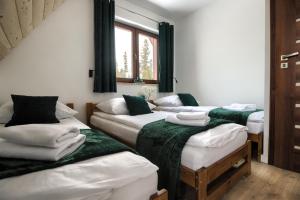 Postel nebo postele na pokoji v ubytování WierchoHouse - domek z jacuzzi