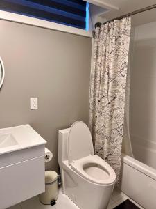 a bathroom with a toilet and a shower curtain at Niagara Getaway across Fallsview in Niagara Falls