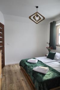 Postel nebo postele na pokoji v ubytování WierchoHouse - domek z jacuzzi