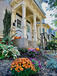 a house with pumpkins and flowers in front of it at Cozy 2B1B Home ｜Walk to BROWN｜RISD｜Pet friendly in Providence
