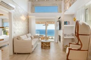 a living room with a view of the ocean at PARGA Villas Collection in Parga