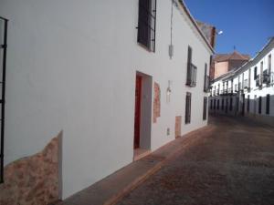 um beco vazio com edifícios brancos e uma porta vermelha em 4 bedrooms house with wifi at Almagro em Almagro