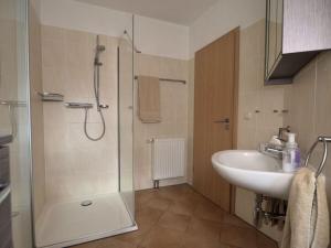 a bathroom with a shower and a sink at Apartment Captain's Terrace in Unter Göhren