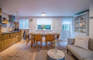 a kitchen and living room with a table and chairs at Carpe Diem Egmond aan Zee by Urban Home Stay in Egmond aan Zee
