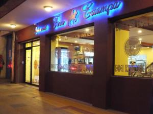 a restaurant with a neon sign on the front of it at HOTEL ALONSO DE ERCILLA in Concepción