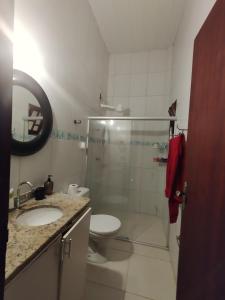a bathroom with a shower and a toilet and a sink at Quarto Praia do Frances in Marechal Deodoro