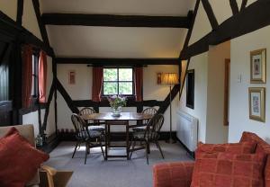 a dining room with a table and chairs and a window at Cider Press in Hereford