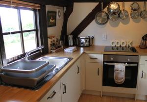 a kitchen with a sink and a counter top at Cider Press in Hereford