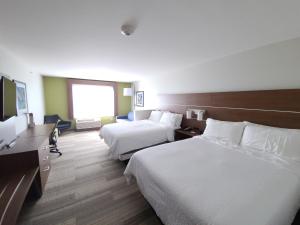 a hotel room with two beds and a desk at Holiday Inn Express & Suites - Nebraska City by IHG in Nebraska City +25 photos