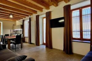 a living room with a couch and a dining room at La Maison de Joanna 3 in Châtillon