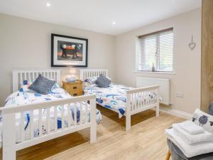 a bedroom with two beds and a chair at 2 Bed in Stanton-by-Bridge 78581 