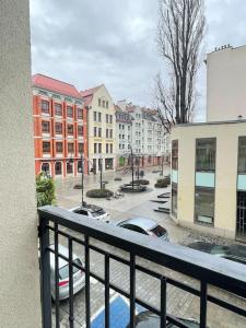 a view of a city street from a balcony at Klimatyczne gniazdko przy Rynku in Wrocław