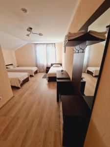 a large room with two beds and a table at Pensiunea turistică MUZE in Rezina