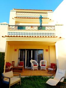 a balcony of a house with chairs at Vistas al Guadiana, Chalet a 10 minutos de la playa in Ayamonte