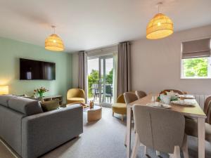 a living room with a couch and a table and chairs at 2 Bed in St. Mellion 87712 in St Mellion