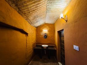 a bathroom with a sink in a building with a ceiling at EUCALIA GLAMPS- VATTAVADA in Vattavada