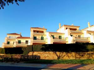 a large building with balconies on top of a wall at Vistas al Guadiana, Chalet a 10 minutos de la playa in Ayamonte