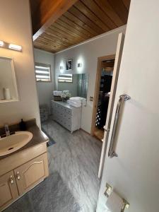 a bathroom with a sink and a mirror at Blue House in Sylvan Lake