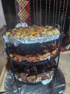 a stack of food on top of a grill at wadi rum fox road camp & jeep tour in Wadi Rum