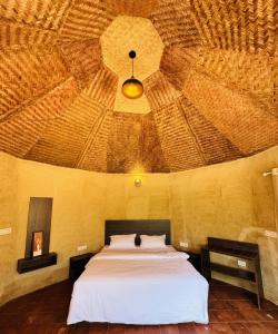 a bedroom with a large bed with a wooden ceiling at EUCALIA GLAMPS- VATTAVADA in Vattavada