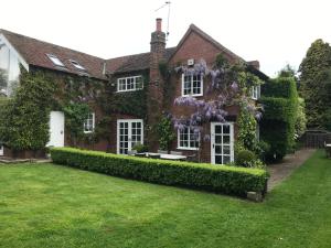 a brick house with a garden in front of it at Well house in Stone